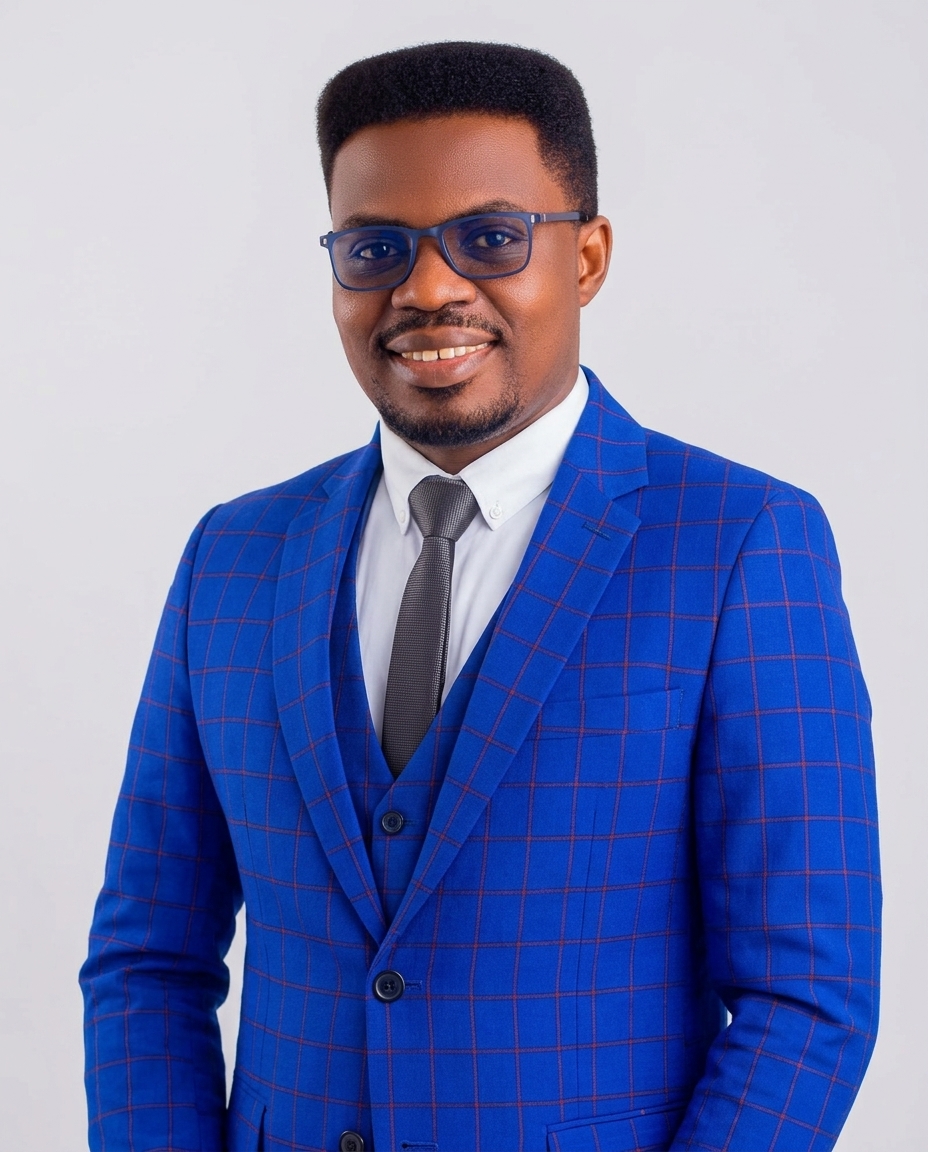Olatokunbo Charles Fatore in a blue checked suit, smiling